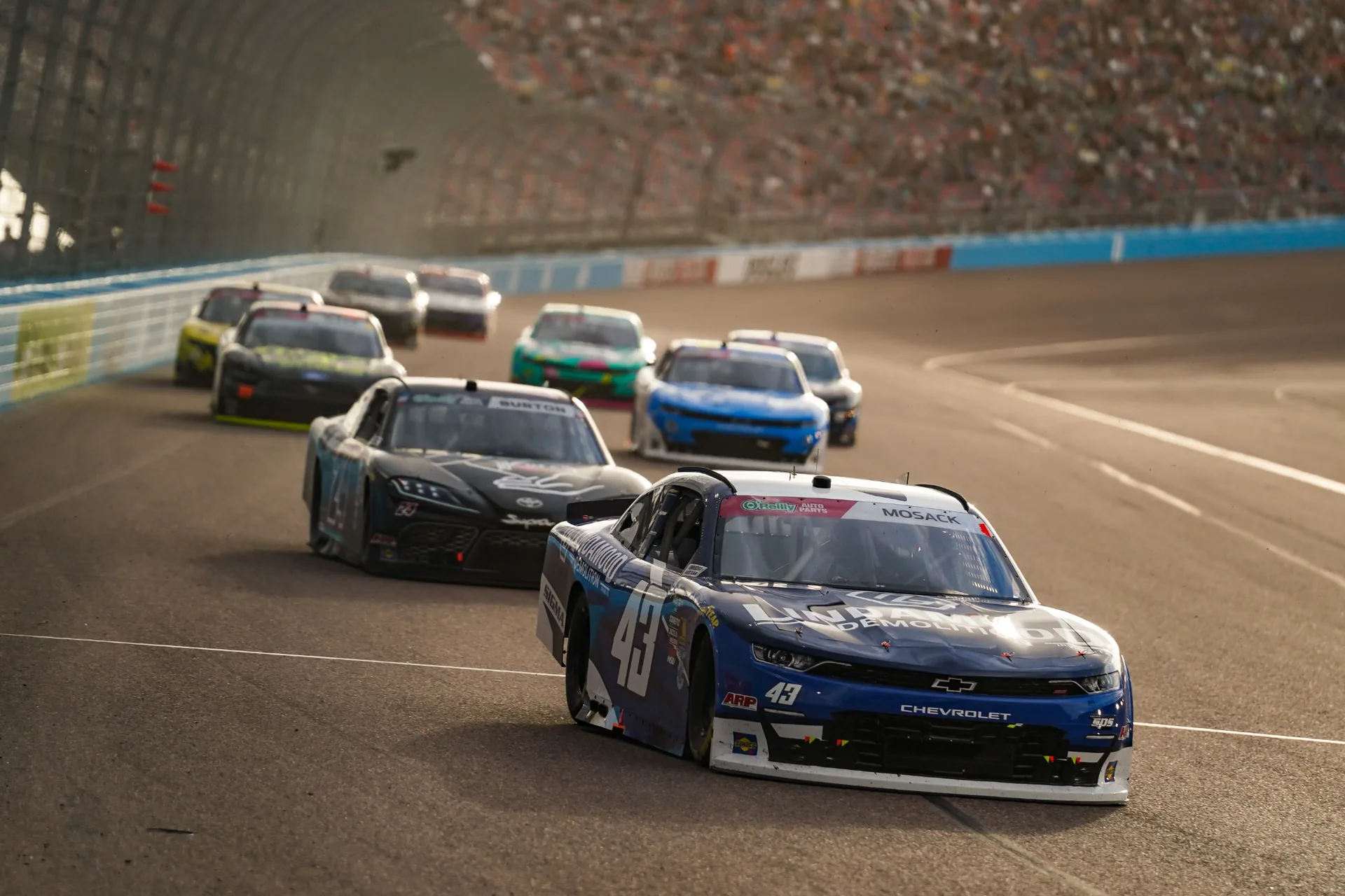 The No. 43 Lindamood Chevrolet runs ahead of a group of racecars at Phoenix Raceway.